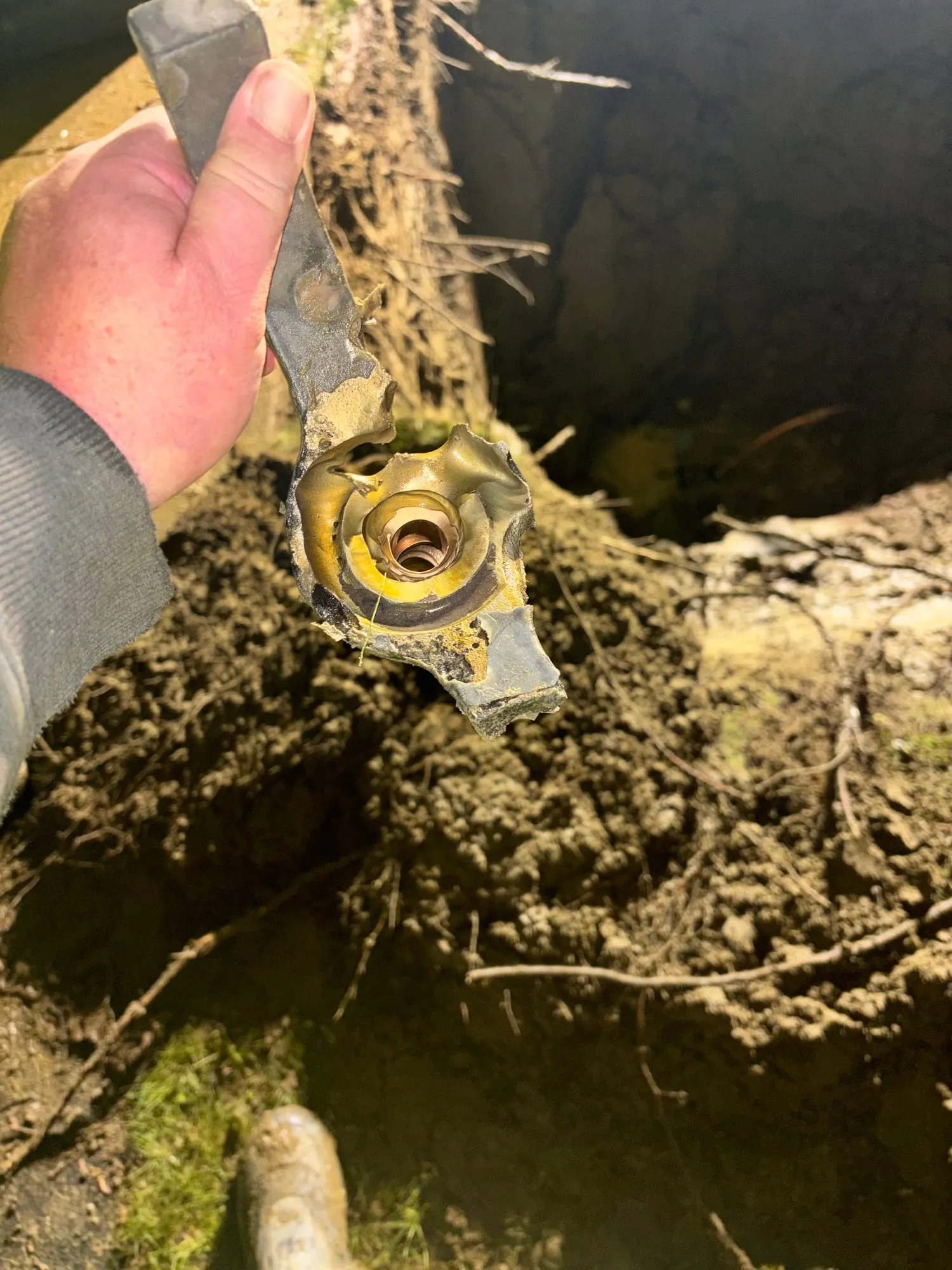 A split fitting dug out of a line in the ground