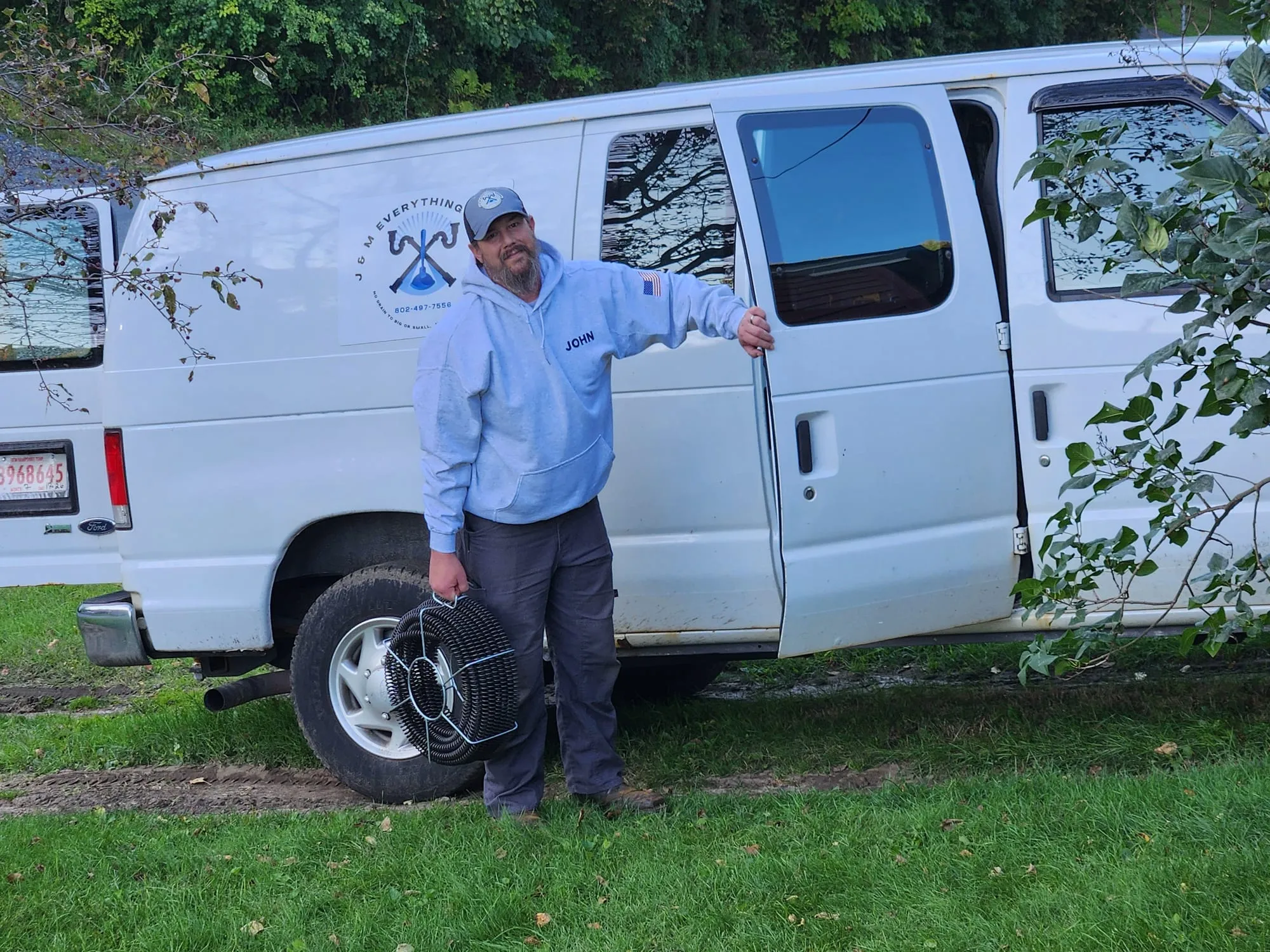 John Haire at the van with a drain cable drum
