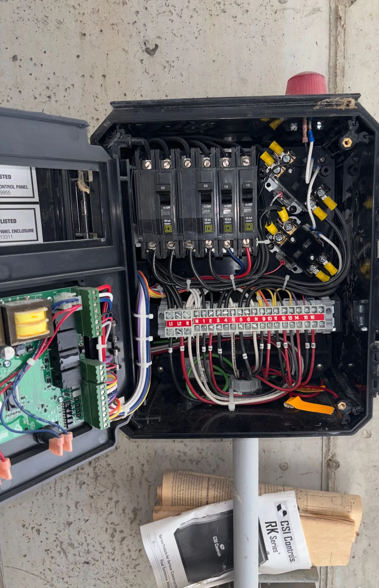 The open control panel of a sewage pump station
